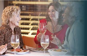 3 ladies drinking and laughing